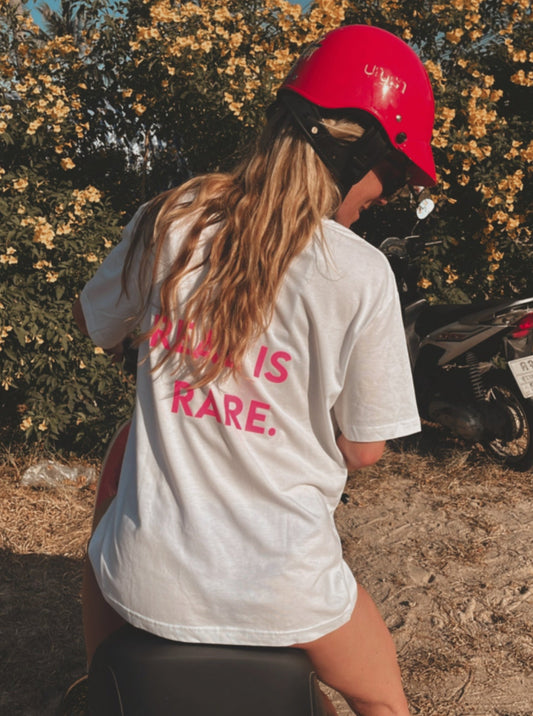 Unisex Relaxed T-Shirt “REAL IS RARE.” (Neon Pink Print)