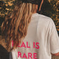 Unisex Relaxed T-Shirt “REAL IS RARE.” (Neon Pink Print)