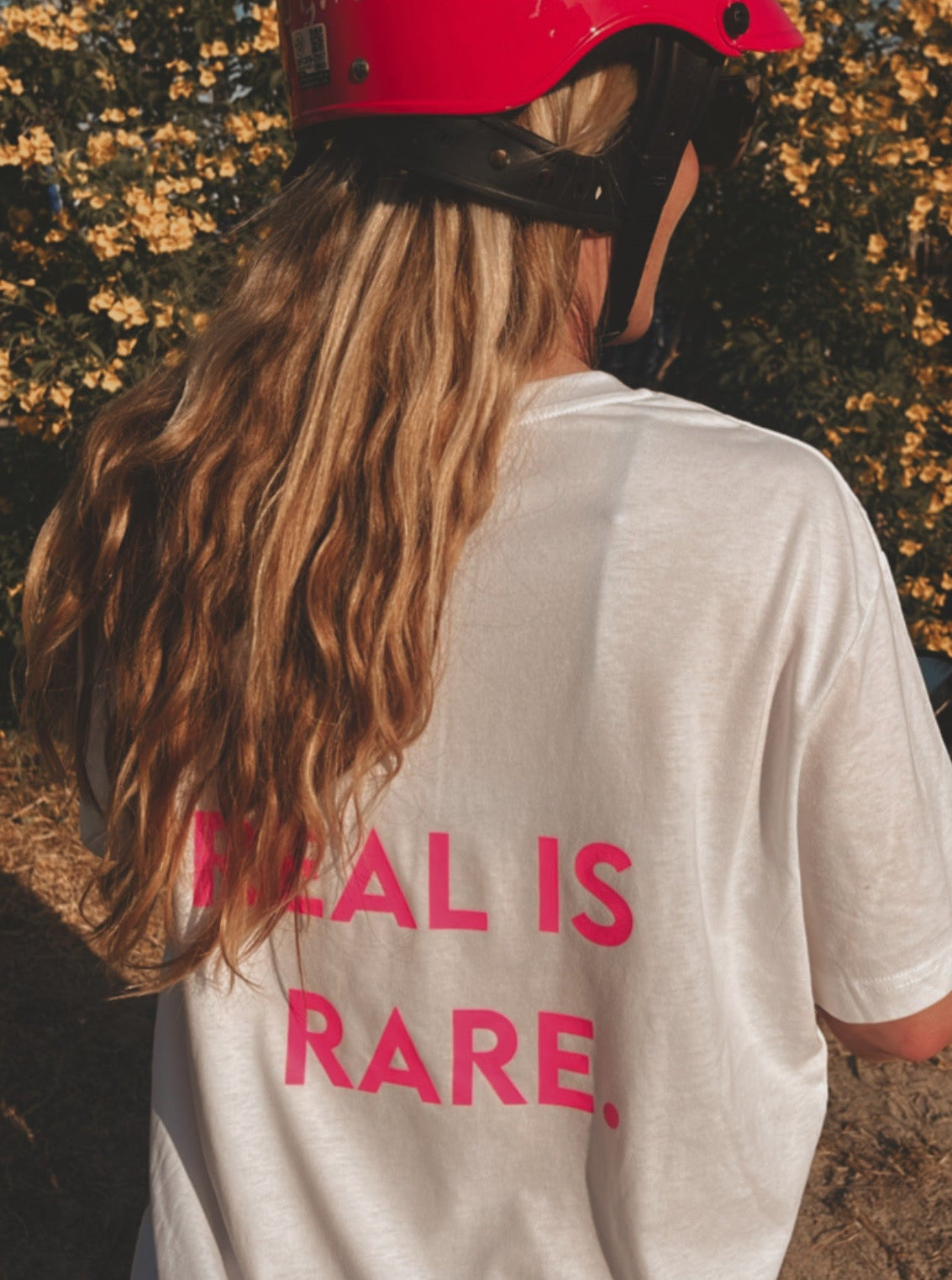 Unisex Relaxed T-Shirt “REAL IS RARE.” (Neon Pink Print)